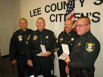 Sergeant Patrick McDonald (second from left) and Deputy Ryan Justham (far right).